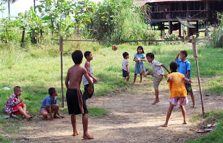Children playing foot volleyball